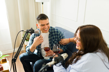 Excited podcast host smiling with his guest for his podcast