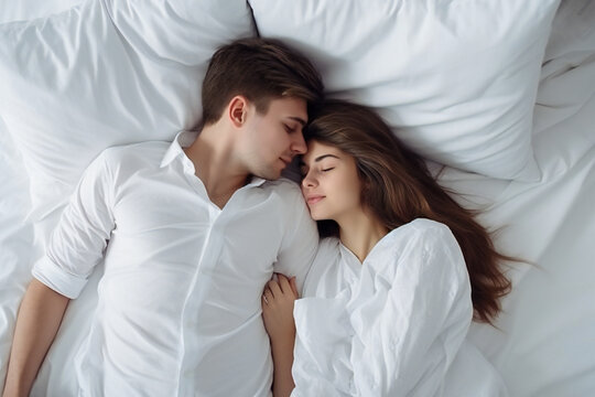 Young beautiful and loving couple wake up while lying