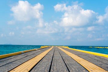 View of the sea at the pier with a long promenade