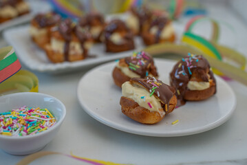 Delicious profiteroles with cream and chocolate glaze