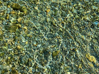 Transparent sea aqua underwater pebbles stones gravel in the seabed