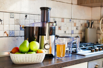 Fresh Juice Preparation with Electric Juicer in Kitchen