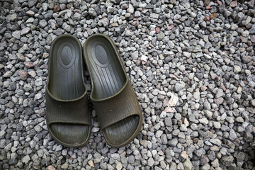 sandals with a background of small rocks or pebbles