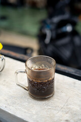 Black coffee in a glass is drunk warm