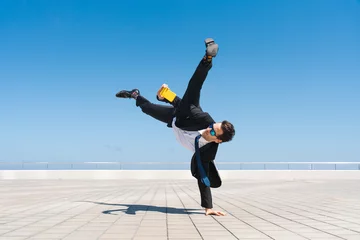 Gordijnen Flexible and cool businessman doing acrobatic trick © oneinchpunch