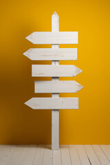Wooden signpost on a yellow background. Copy space.