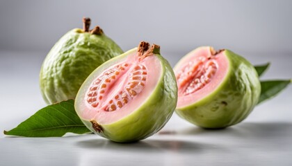 Two green fruits with pink interiors
