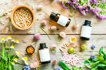 Herbal medicine with flowers on wooden background top view copy space. Homeopathy and Ayurveda concept.