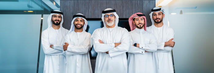 Group of corporate arab businessmen meeting in the office - Business people wearing emirati...