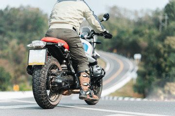 Obraz premium motorcycle in a sunny motorbike on the road riding.with sunset light. copyspace for your individual text. dry road 