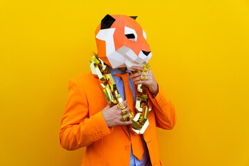 Cool man wearing colorful stylish suit with 3d origami animal funny mask on isolated colored background - obrazy, fototapety, plakaty