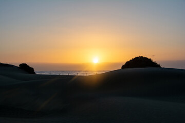 Sunrise over the sand dunes with sea