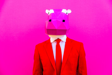 Cool man wearing colorful stylish suit with 3d origami animal funny mask on isolated colored background