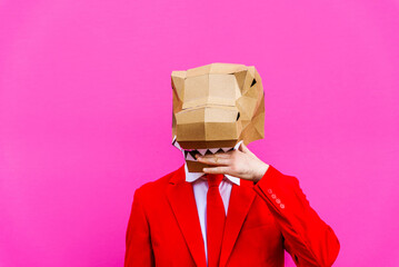 Cool man wearing colorful stylish suit with 3d origami animal funny mask on isolated colored background