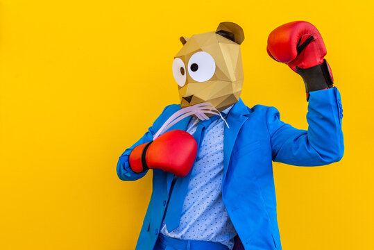 Cool man wearing colorful stylish suit with 3d origami animal funny mask on isolated colored background
