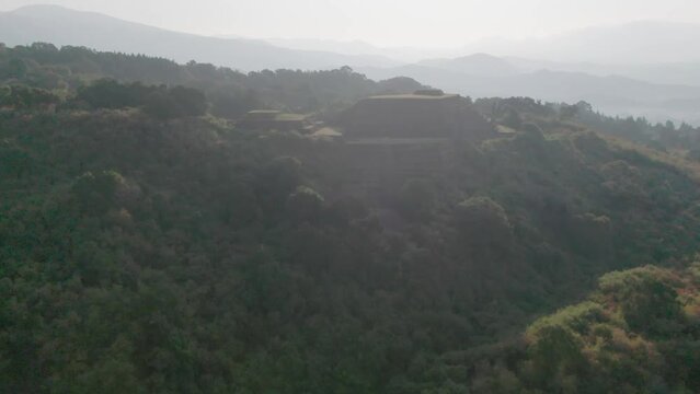 Purepecha Piramid in Mexico, the drone fly over the mountain at sunrice to reveal the piramid