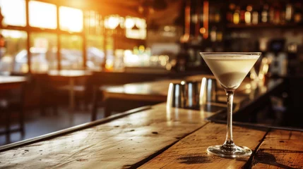 Fototapeten Martini cocktail on bar counter, sunset light © Kondor83
