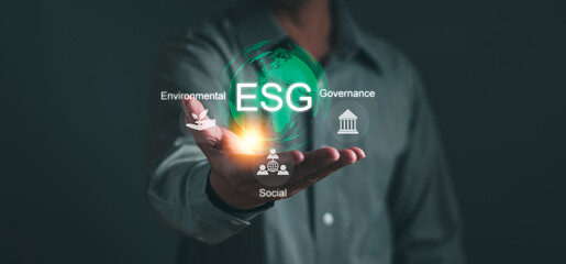 Environmental, social and governance concepts ESG, sustainable organizational development ,Businessman's hands hold green ESG icons to plan investment with environmentally friendly businesses