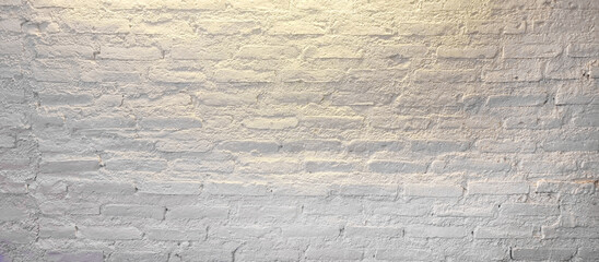close up grunge white brick wall with yellow light from above in minimal style. white empty brick...