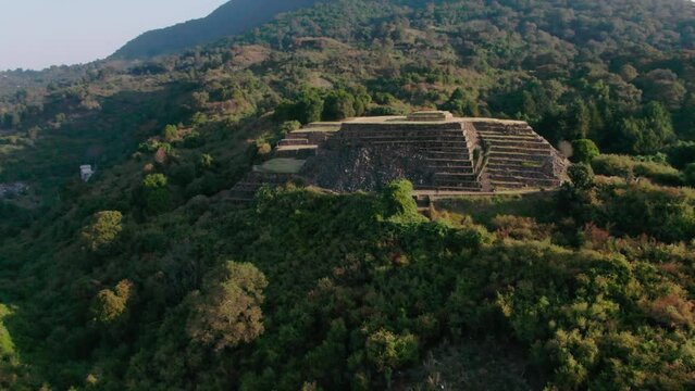 Purepecha Piramid in Mexico, the drone fly over the mountain at sunrice to reveal the piramid