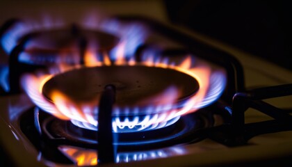 A stove with a blue flame on the burner