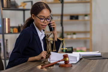 Portrait of young female Lawyer or attorney working in the office, analyzing data, reading contract...