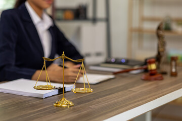 Portrait of young female Lawyer or attorney working in the office, analyzing data, reading contract documents work with law books hammer of justice Consulting lawyer concept.