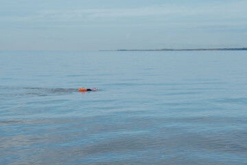 Open water swimmers in the ocean along the English Coast.