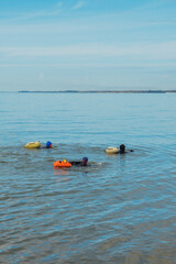 Open water swimmers in the ocean along the English Coast.