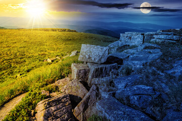 landscape with stones on the hillside with sun and moon at twilight. day and night time change on...