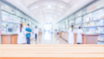 Empty natural wood counter top with blur pharmacy background