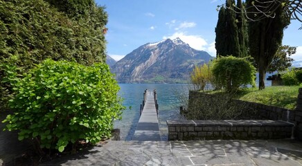 Wooden pier on mountain lake. Lake Lucerne, Switzerland.