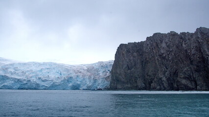 Glacier meeting the sea along a rugged cloastline on Elephant Island, Antarctica