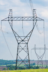 high-voltage power line support on the field. transmission of electricity and information over long distances. vertical frame