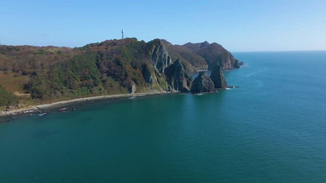 Cinematic aerial shot of coastal cliffs in Muroran city in Hokkaido, Japan