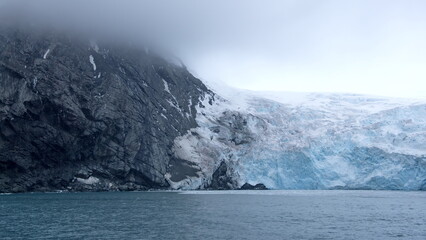 Glacier meeting the sea along a rugged cloastline on Elephant Island, Antarctica