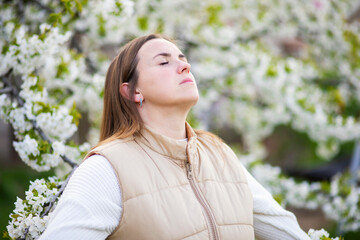 Woman Enjoying Serenity in Spring Blossoms