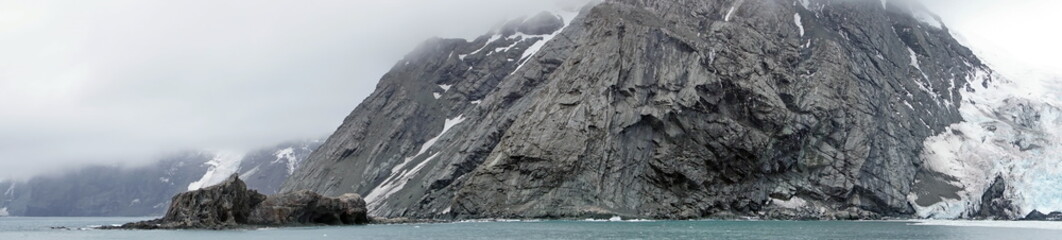 Panorama of a glacier meeting the see on the rugged coastline of Elephant Island, Antarctica
