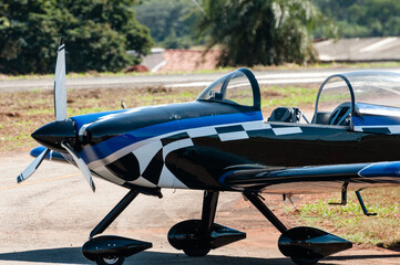 Fototapeta na wymiar Single-engine aerobatic display plane being parked at a flying club