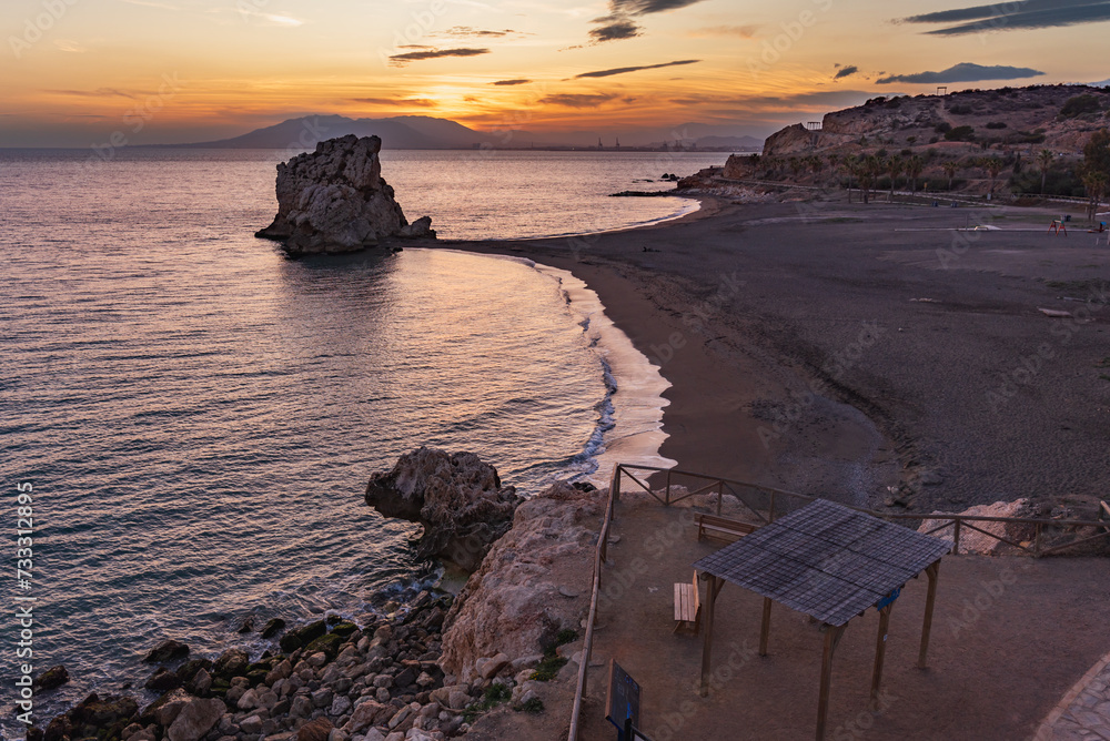 Wall mural Playa Peñon del Cuervo, beach in the city of Malaga with a rock formation that divides the beach in two, located in the eastern part of the city, Costa del Sol.