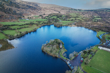 Timeless tranquility in Gougane Barra, County Cork, Ireland – where water flows gracefully around a historic chapel, capturing the essence of peaceful beauty