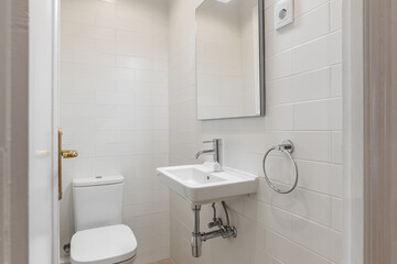 Fototapeta na wymiar Small White Tiled Bathroom with Modern Fixtures