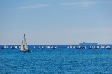 Fototapeta premium boats in the Mediterranean with a bottom container transporter and small boats and a sailboat