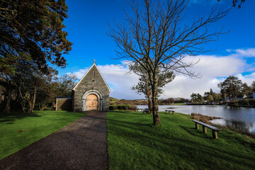 Timeless tranquility in Gougane Barra, County Cork, Ireland &ndash; where water flows gracefully around a historic chapel, capturing the essence of peaceful beauty
