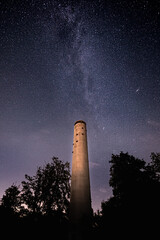 The Milky Way shines in a starry night behind the Mahlberg tower in the northern Black Forest