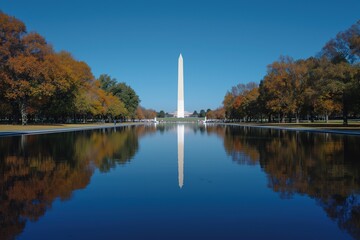 The Washington Monument is seen reflecting in the calm waters of the reflecting pool.