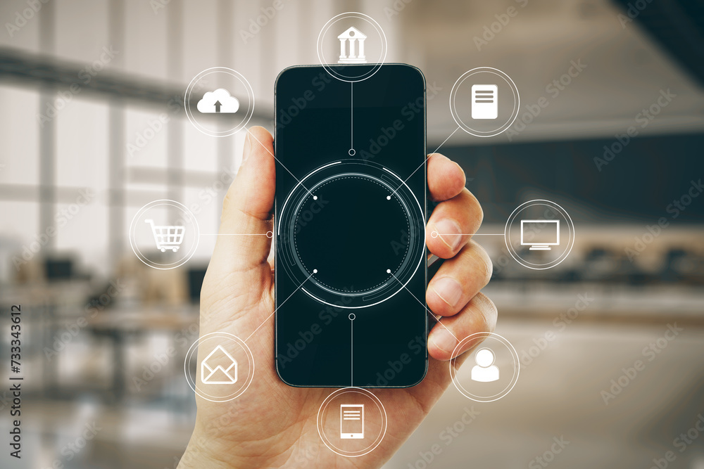 Poster close up of hand holding smartphone with creative round digital interface with various icons on blur