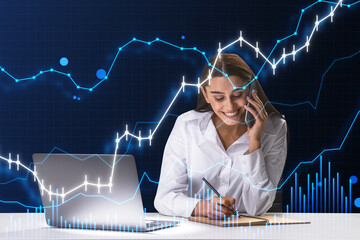 Attractive happy european businesswoman talking on the phone and doing paperwork at desk with laptop and growing business chart on blurry blue background. Financial growth, trade and stock concept. - Powered by Adobe