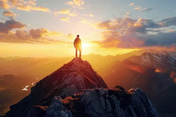 Tuinposter A man standing on top of a mountain as the sun sets. Goals and achievements concept photo composite. © darshika