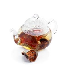 Bael fruit tea in glass teapot isolated on white